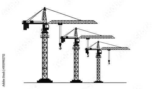 Three construction cranes of varying heights