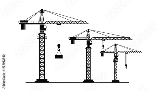 Three construction cranes of varying heights