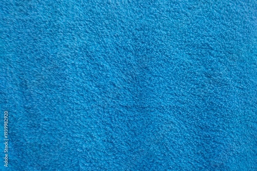 Bright blue soft terry cloth cotton towel fabric textile texture background