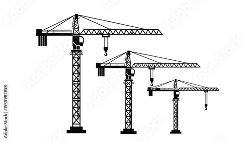 Three construction cranes of varying sizes
