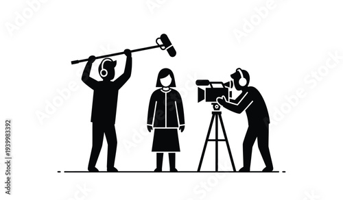 Silhouetted cameraman filming a woman as a man hits a gong with a mallet