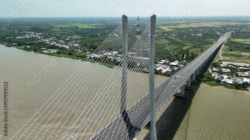 Cao Lanh City, Dong Thap, Southwest Vietnam – 4K aerial drone footage of cable-stayed bridge crossing the Mekong River with rural houses, fruit farms in the delta landscape, transportation and traffic