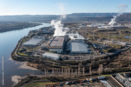 Fotografie Aerial drone picture of a large data center campus with cooling steam, electrical substation along the Columbia River in The Dalles, Oregon, USA