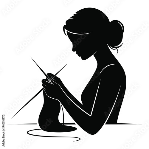 Profile silhouette of woman knitting garment with long needles and soft yarn on table representing traditional craftsmanship and peaceful home hobby