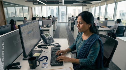 Professional Woman Using Desktop Computer in Open Office