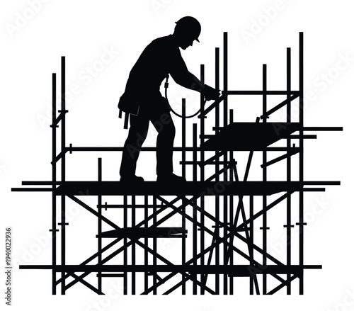Construction worker on scaffolding with power tool