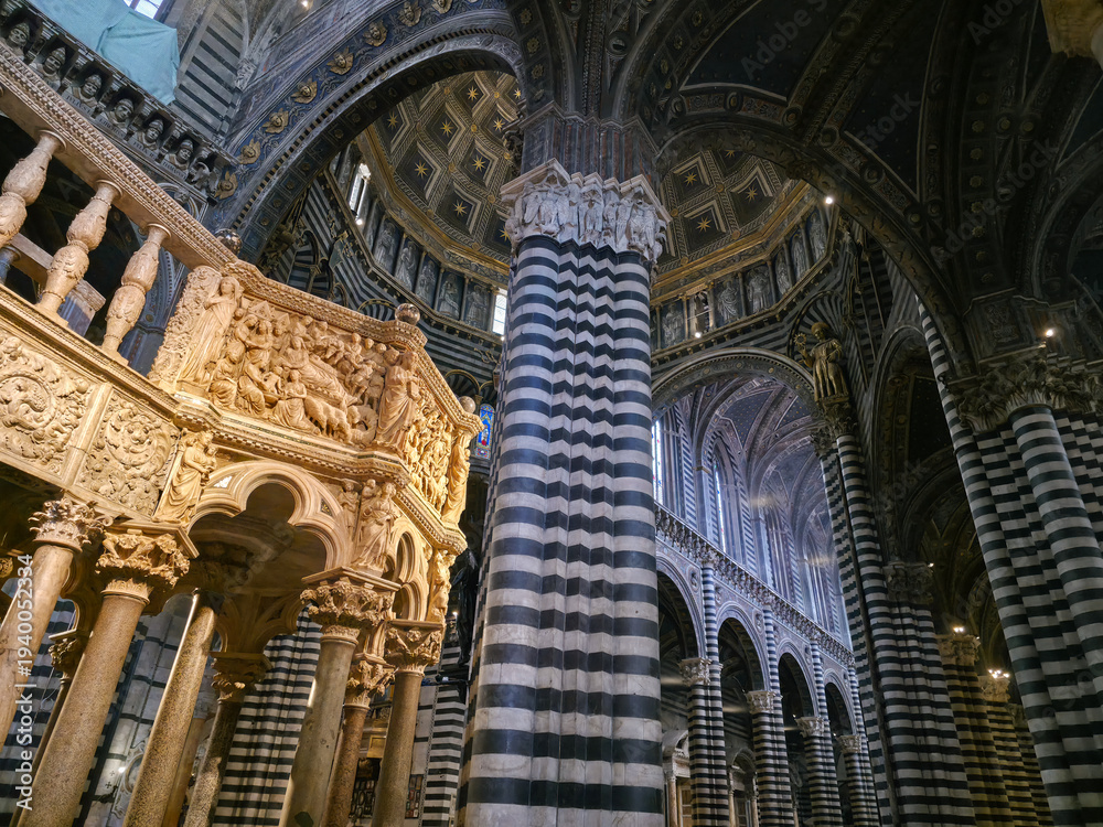 Obraz premium Interior of Siena Cathedral featuring Nicola Pisano's Gothic pulpit, striped marble columns and the ornate dome, Tuscany, Italy