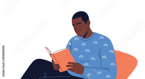 Young black man wearing a blue sweater is peacefully immersed in reading an orange book while relaxing at home.