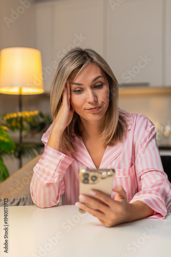 Εκτύπωση καμβά Adult woman at night home scrolls news on smartphone bored tired heavy eyes feels stress