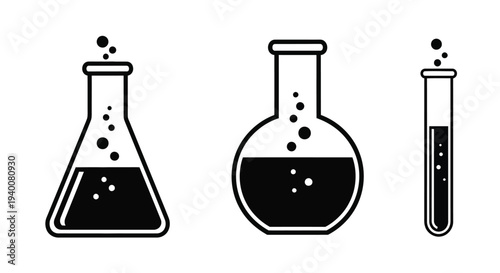 Three laboratory beakers and a test tube with liquid contents