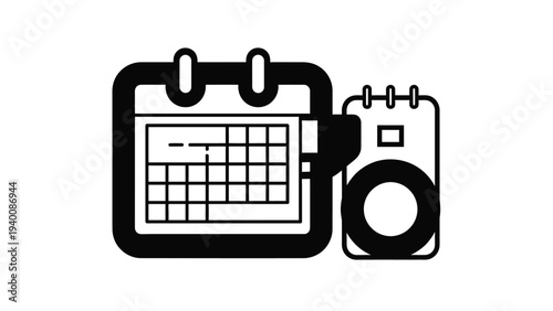 A calendar and camera sit side by side on a table indoors.