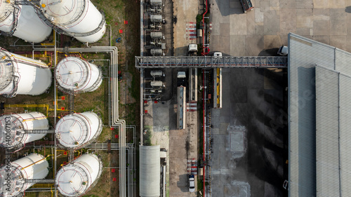 Aerial view of industrial oil storage tank farm and distribution terminal with tanker truck, Fuel reserves and oil refinery infrastructure, Fuel distribution center energy product fuel storage tank.