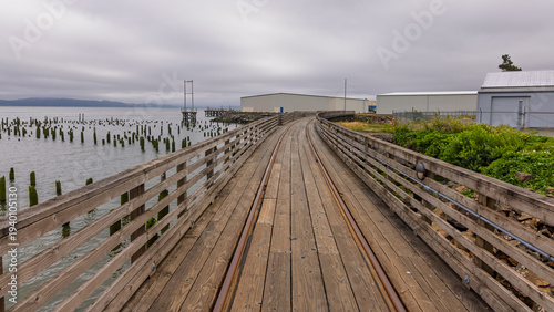 Astoria Riverwalk boardwalk with train tracks in Oregon.