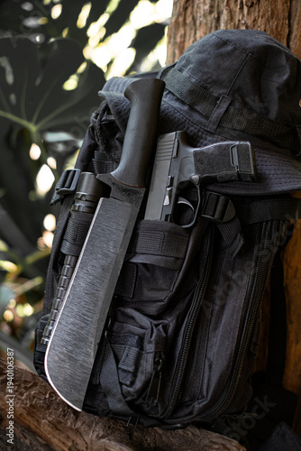 machete knife and a hiking backpack rest on a log.
