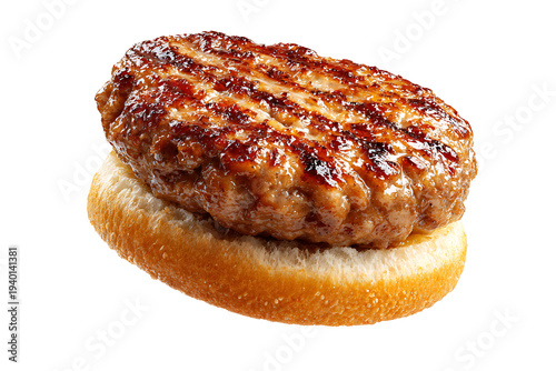 A grilled burger patty on a toasted bun on a table indoors.