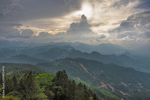 View from Ambuluwawa Tower, multi-religious temple complex located in Gampola, in Sri Lanka. Dramatic Mountain Landscape with Forest and Cloudy Sky at Sunset or Sunrise Time