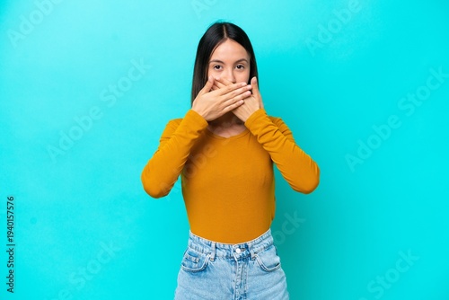 Young caucasian woman isolated on blue background frustrated and covering ears