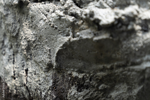 Macro Texture of Rough Grey Cement on a Dark Surface