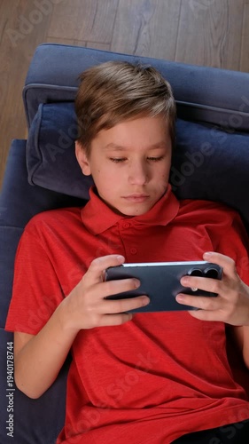 12 Year Old Teenage Boy Using Smartphone at Home, vertical video