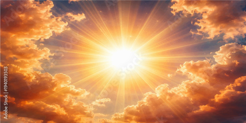 Beautiful summer sunrise creates an abstract orange and yellow cloudscape as the sunlight pierces through the blue atmosphere at dusk