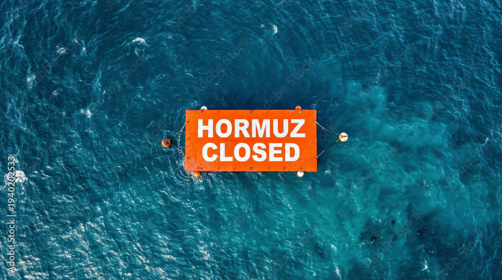 Fototapeta premium Sign states Hormuz closed in busy shipping route on open water
