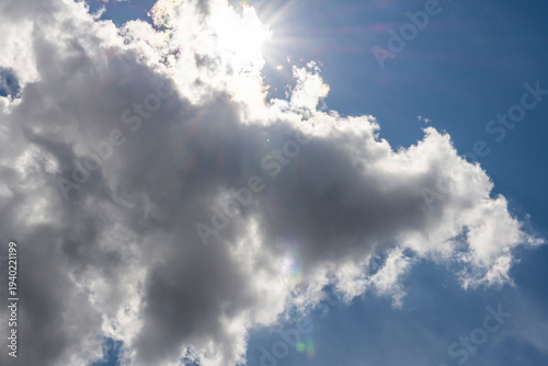 Spectacular cumulus clouds in the morning sky. A close-up of beautiful multicolored cumulus clouds against a blue sky and sunset.