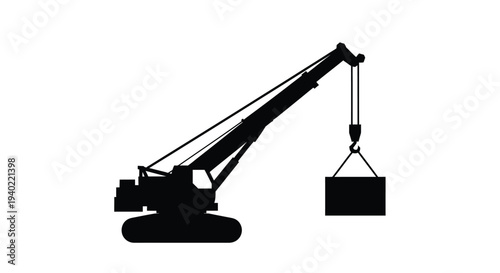 Construction crane lifting a load a striking black silhouette