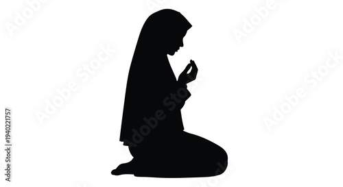 A kneeling woman in traditional dress captured in stark silhouette