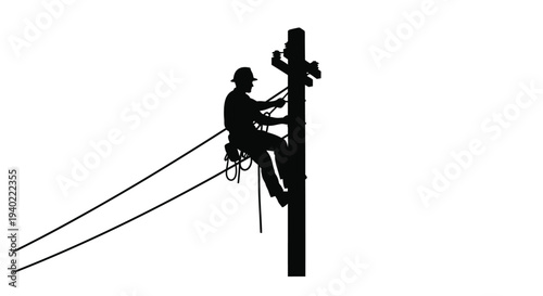 Lineman working on a utility pole a striking black silhouette