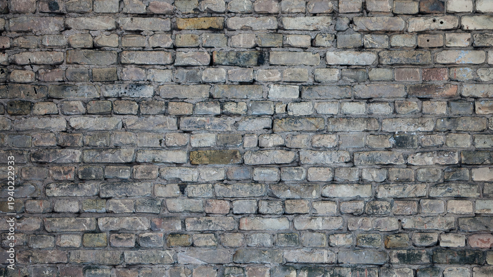 Obraz premium Old brick wall of a building, the photo shows the texture of yellow-brown bricks of the building's facade