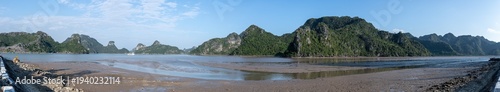 Panoramic landscape showing cat ba national park limestone karsts and tidal flats under blue sky