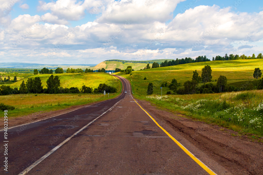 Naklejka premium road in mountains, blissful landscape