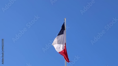 Flag of France, French tricolor flag waving in blue sky. 
