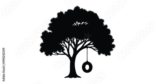 A dark tree with a tire swing hangs peacefully a striking silhouette