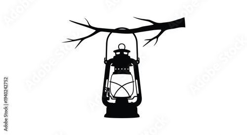 Antique lantern hanging from a branch stark black silhouette