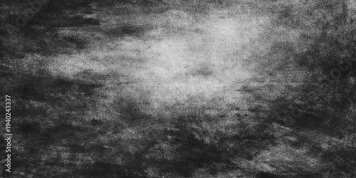 A dark and aged black and white grunge background featuring a rough textured stone wall surface with a dirty vintage pattern for a moody wallpaper backdrop