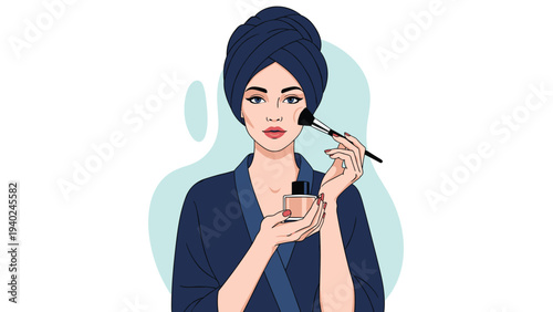 Beautiful woman wearing a dark blue robe and head towel applying makeup with a brush while holding a cosmetics bottle.
