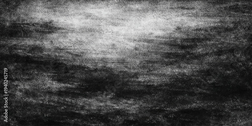 A dark and weathered black and white grunge background features an old textured wall surface with a dirty gray concrete pattern and aged vintage paper details for a rough industrial backdrop