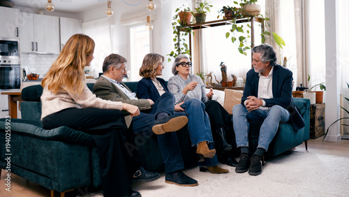 Fotografía Group of diverse senior friends sitting on a couch, engaging in lively discussio