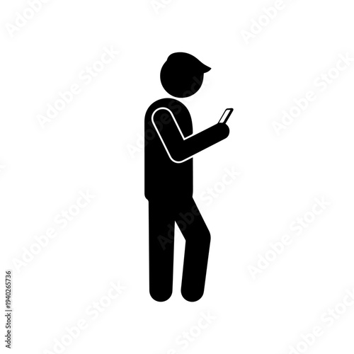 Connected in the Digital World: A silhouette captures the modern individual engrossed with technology, focused on the screen of a handheld device, symbolising connectivity.