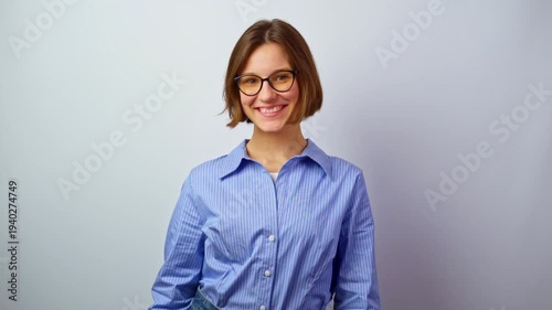 Beautiful girl in glasses looking at camera smiling pretty young girl wearing eyeglasses friendly expression warm smile happy with new frames studio portrait optics vision correction