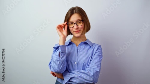 Pretty girl in glasses adjusting glasses smiling young woman fixing eyewear comfortable fit happy expression natural gesture studio portrait optics fashion accessory