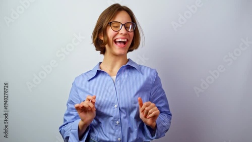 Beautiful girl putting on glasses for vision winking laughing smiling happy young woman trying eyeglasses multiple emotions joy fun successful purchase studio