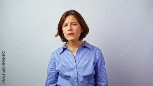 Beautiful girl squinting eyes due to poor vision young woman with bad eyesight straining to see without glasses vision problems eye health concerns studio portrait