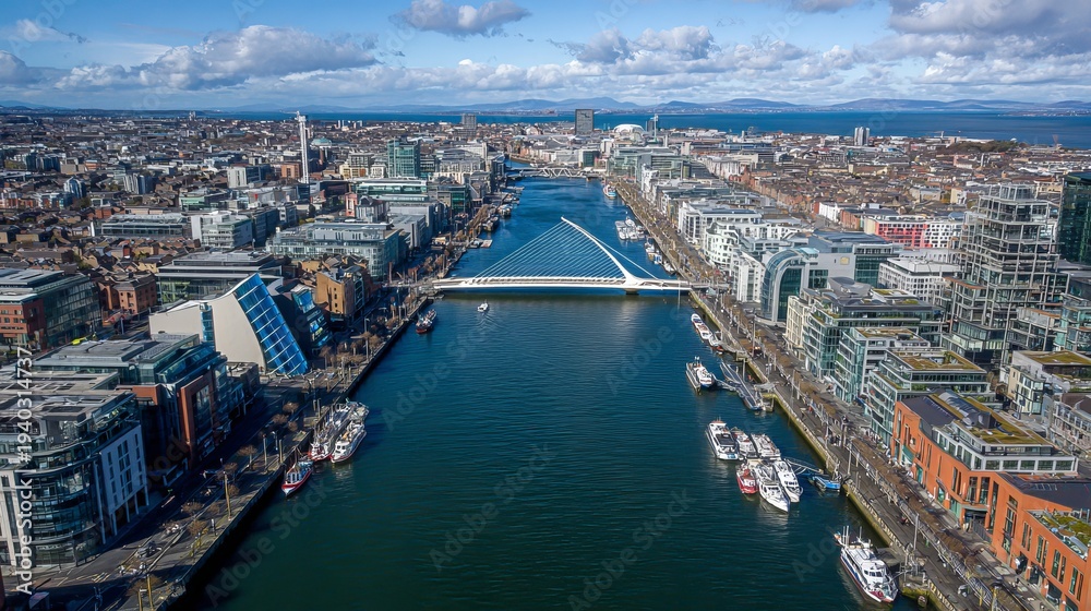 Obraz premium Dublin's skyline and its unique Samuel Beckett Bridge appear from above.