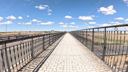 French Way of Saint James - pedestrian path over the highway leaving Fromista in direction to Carrion de los Condes, province of Palencia, Castile and Leon, Spain