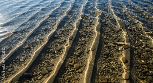 Close-up of Tide Marks and Pebbles on a Sunny Beach Shore