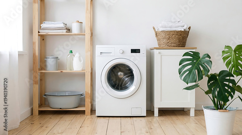 Modern laundry room interior with white washing machine, wooden shelves, cleaning supplies, and green Monstera plant on a light wood floor against a white wall