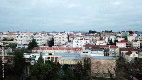 Cinematic aerial drone panorama of Coimbra, Portugal — historic European cityscape with skyline, landmarks and architecture in daylight, a high-angle travel view over urban rooftops