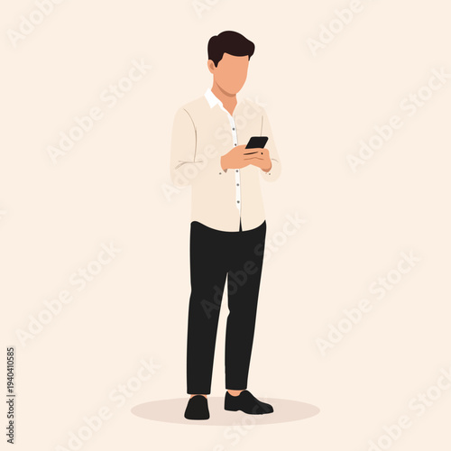 Man standing alone holding phone in hand looking down